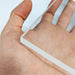 Corner of a 10mm thick clear acrylic sheet in a person's hand